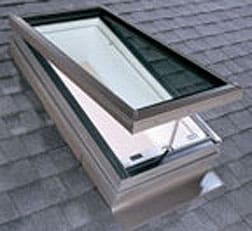 A skylight roof window with a manual opening, on a house's ceiling.