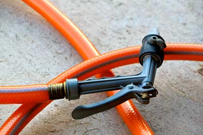 Use a garden hose with nozzle control to water-test for roof leaks.