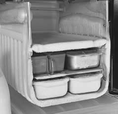 Freezer compartment of a refrigerator including frozen ice cube trays.
