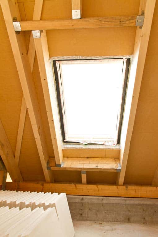 Interior framing shows how joists are constructed around the skylight opening in the roof.