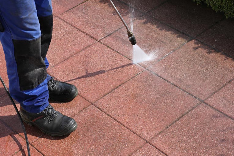 Power washing is an effective way to clean grit from driveways, patios, and walkways.