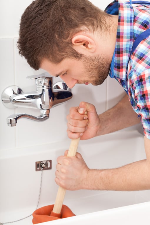 Use quick, stabbing motions with a flat drain plunger to clear a drain blockage. 