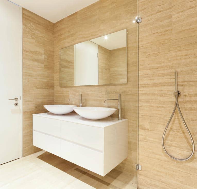 European-style frameless bath cabinet has flush doors with hidden hinges.