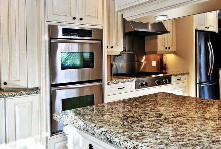 Built-in double ovens are complimented by a drop-in gas range.