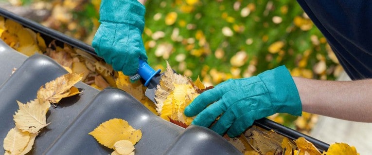 A small garden trowel makes scooping debris out of gutters an easier job. Wear gloves to protect your hands from muck, sharp metal, and sheet metal screws.