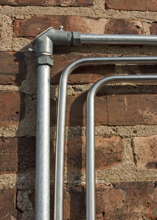 Thinwall metal conduit can be curved to take corners or, for large sizes, can be fitted with elbows.