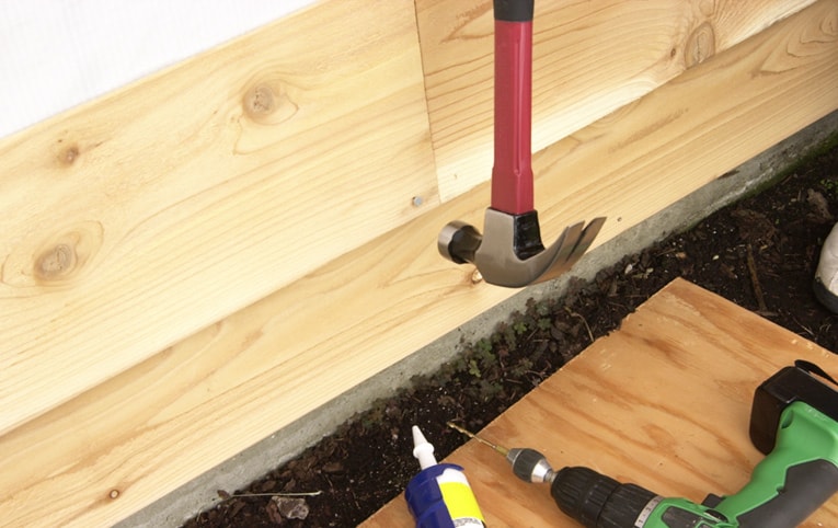 Join boards end-to-end over a stud location, predrill, caulk the joint, and nail.