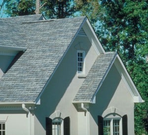 External view of a white house with an asphalt gable roof.