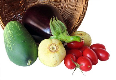 basket of vegetables, including squash eggplant, and radishes
