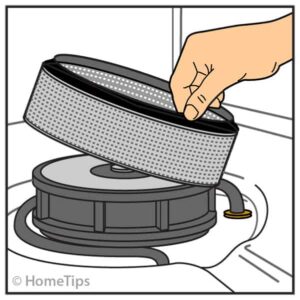 Man’s hand lifting out a strainer at the base of a dishwasher.