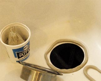A coil of plumber's putty, surrounding a bare sink hole.