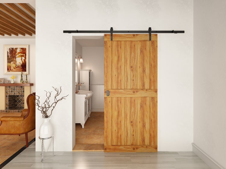 Wooden sliding barn door of a bathroom with a flat-track.