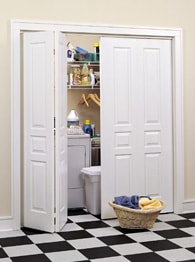 Partly opened white bi-fold doors of a utility closet.