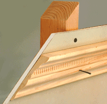 attaching_trim_securely Illustration of a nail, penetrating through a trim, wall, and stud.