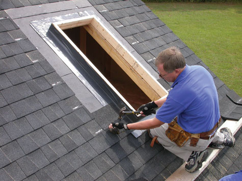 Before adding the skylight, this contractor is building a curb and weaving the curb's flashing into the shingles.