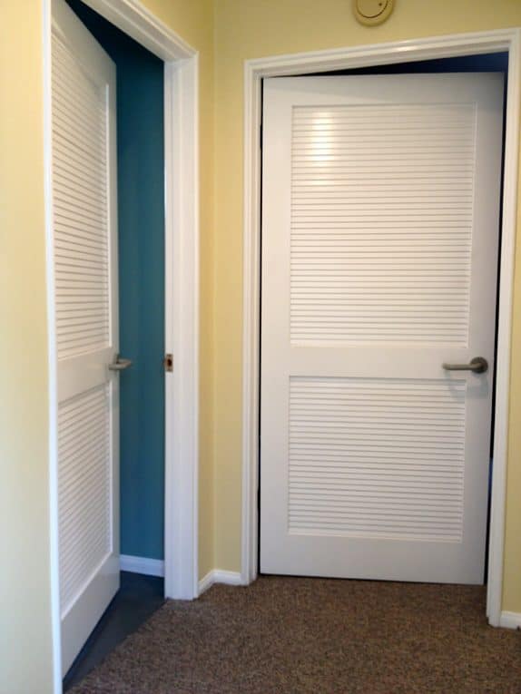 Two rooms with white false louver doors.