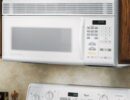 A white over-the-range microwave oven, fitted into an upper cabinet.