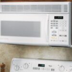 A white over-the-range microwave oven, fitted into an upper cabinet.