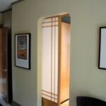 Wooden pocket sliding door with translucent panels.