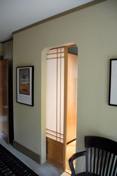 Wooden pocket sliding door with translucent panels.