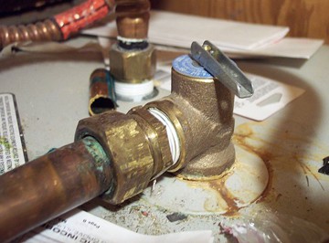 A defective TP relief valve, with rust around connections. 