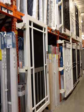 Various screen and storm doors displayed in a rack.