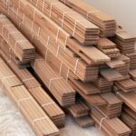 Pile of light hardwood flooring planks.