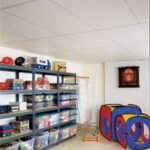 A white suspended ceiling with metal grids on a child's playroom.