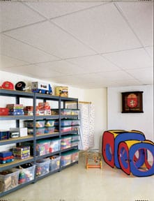 A white suspended ceiling with metal grids on a child's playroom.