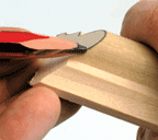 Man’s hands marking a curved cut with a pencil.