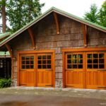 Craftsman bungalow-style garage with swing-out, real wood carriage, dual garage doors.