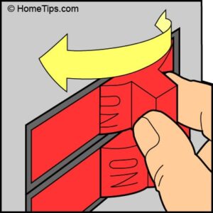 Fingers turning off two red circuit breakers.