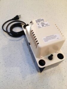 A condensate pump for a central air conditioner, with power cable.