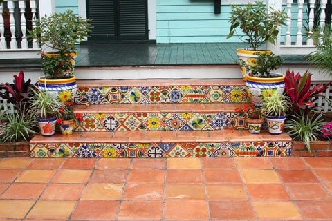 Colorful decorative tiles punctuate the Saltillo pavers on these front stairs.