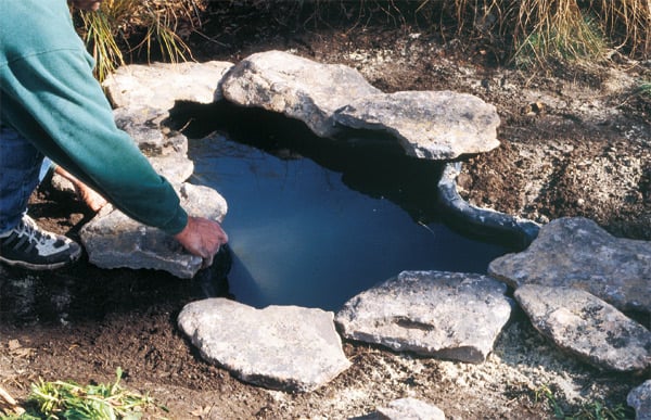 placing stones around liner