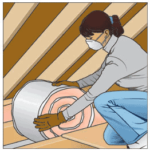 A woman installing a roll of insulation between ceiling joists.