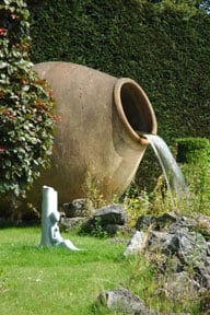 ceramic pot waterfall spilling water in garden feature