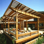 Detached backyard patio deck with a pergola roof.