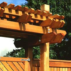 A wooden arbor entry on a house's gated fence.