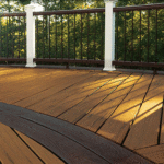 Outdoor composite deck with two-toned wood-like design including railings.