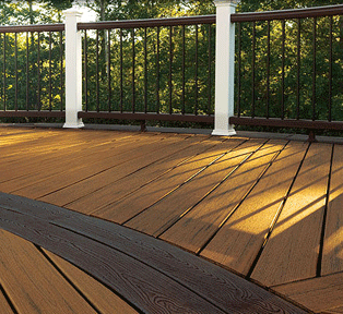 Outdoor composite deck with two-toned wood-like design including railings.