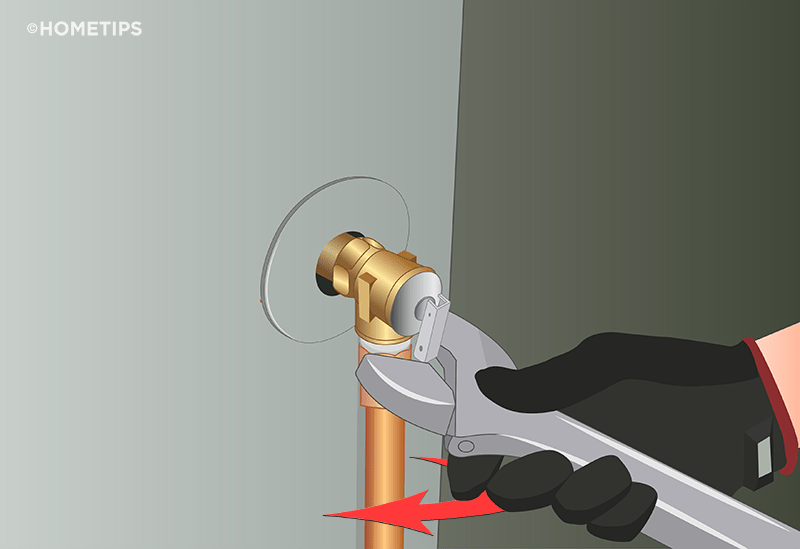 Gloved hand turns a wrench on the discharge pipe, removing it from the T&P valve.