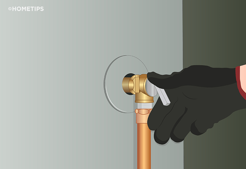 Gloved hand lifting the lever on a T&P valve on side of a water heater.