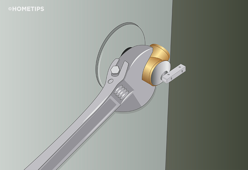 Wrench unscrewing a T&P valve from the side of a water heater. 