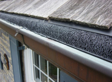 A fitted black UV-protected nylon gutter guard tucked inside. 