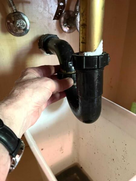 unscrewing coupling nuts on sink trap