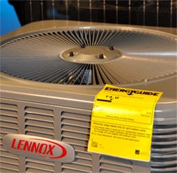 A Lennox air conditioning unit with a yellow EnergyGuide label.