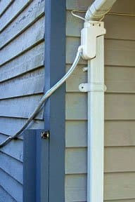 Special downspout attachment diverts rainwater. Photo: Rain Saver