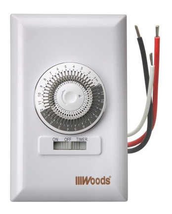 Mechanical spring-wound timer switch, with electrical wirings over a white background.
