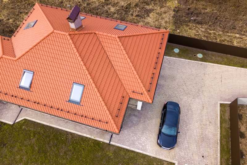 Aerial view of a terracotta style metal roof on a house.